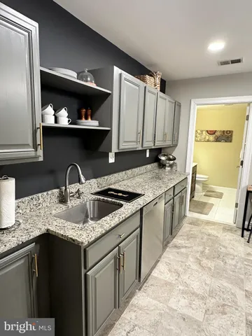 a kitchen with stainless steel appliances granite countertop a sink stove and cabinets