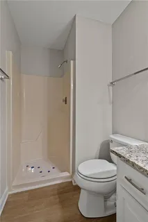 a bathroom with a toilet and a shower