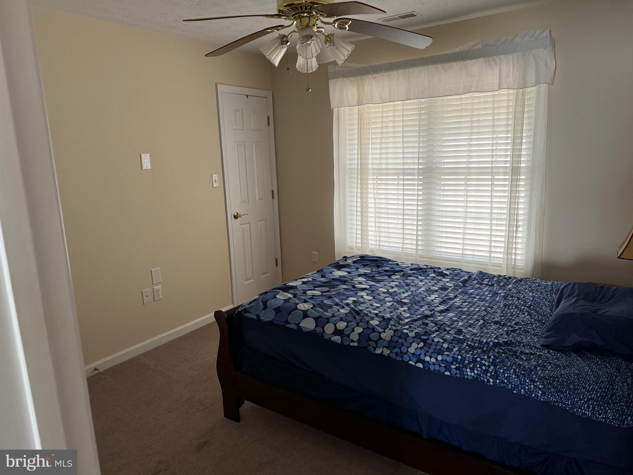 115 Gloucester Road Front Royal, VA 22630 - Photo 11 of 14 a bedroom with a bed and a chandelier