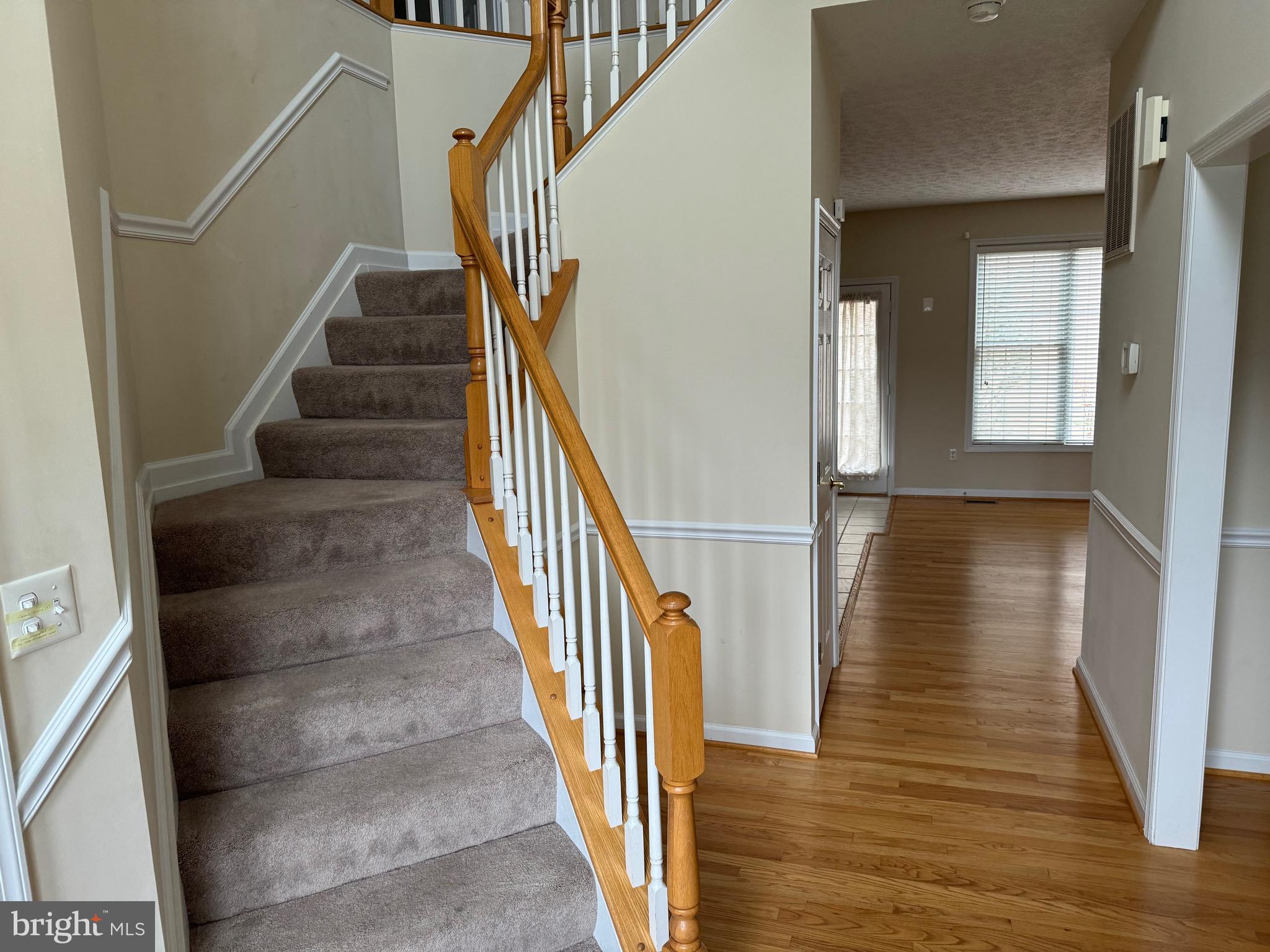 115 Gloucester Road Front Royal, VA 22630 - Photo 2 of 14 a view of a hallway with wooden floor and staircase