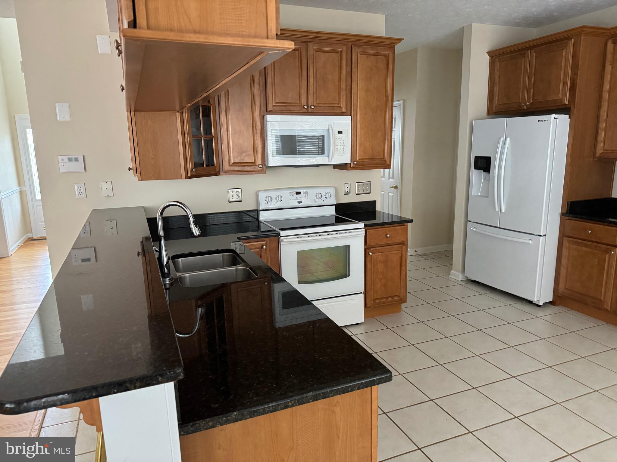 115 Gloucester Road Front Royal, VA 22630 - Photo 6 of 14 a kitchen with a refrigerator stove and microwave