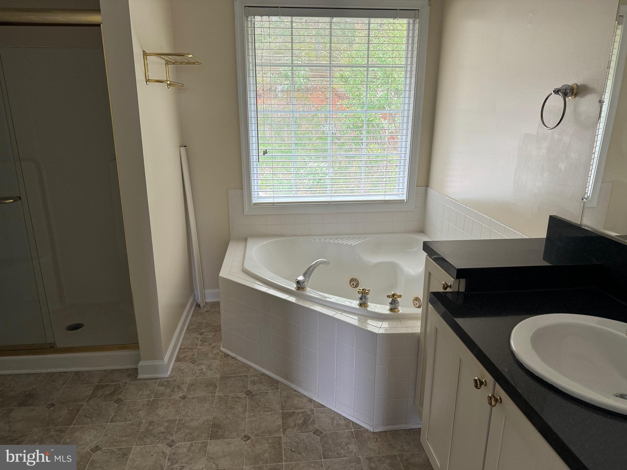 115 Gloucester Road Front Royal, VA 22630 - Photo 10 of 14 a bathroom with a granite countertop sink and a bathtub