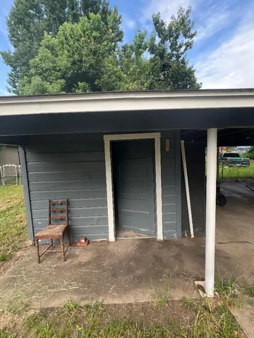 a backyard of a house with outdoor seating and yard in back