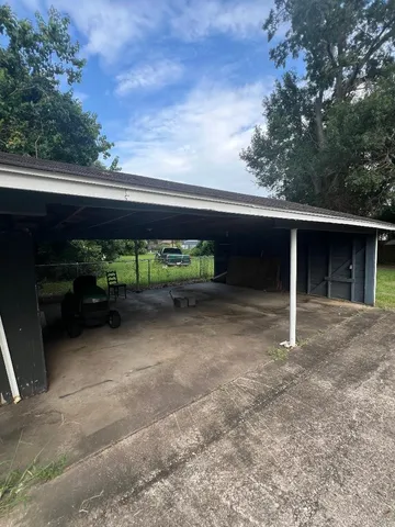 a backyard of a house with table and chairs