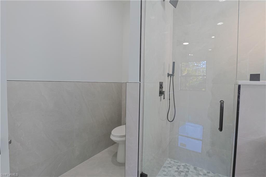 809 Williams Avenue Lehigh Acres, FL 33972 - Photo 11 of 33 a bathroom with a granite countertop shower