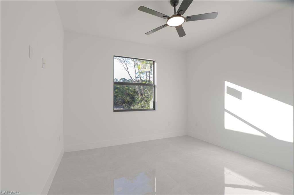 809 Williams Avenue Lehigh Acres, FL 33972 - Photo 14 of 33 an empty room with windows and fan