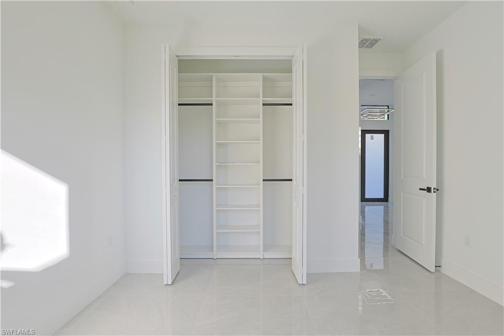 809 Williams Avenue Lehigh Acres, FL 33972 - Photo 15 of 33 an empty room with windows and closet