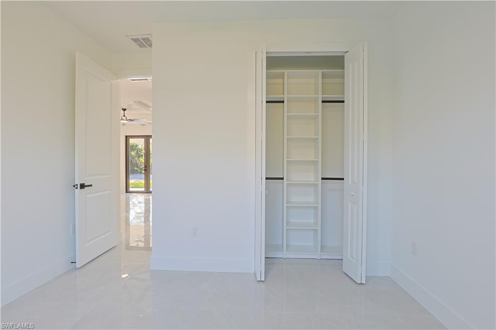 809 Williams Avenue Lehigh Acres, FL 33972 - Photo 18 of 33 an empty room with closet and a bathroom