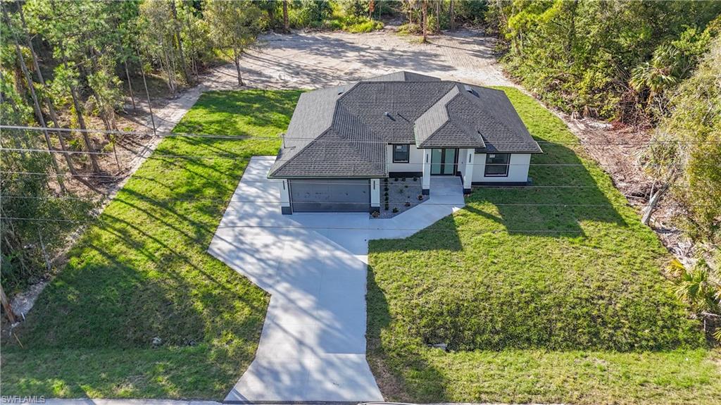 809 Williams Avenue Lehigh Acres, FL 33972 - Photo 2 of 33 a aerial view of a house with a yard