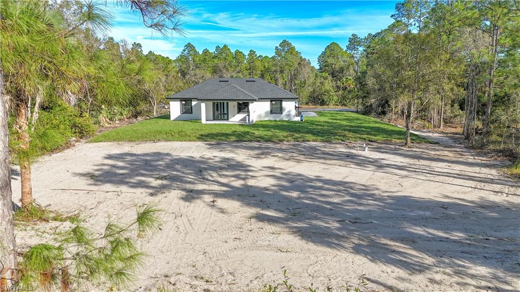 809 Williams Avenue Lehigh Acres, FL 33972 - Photo 28 of 33 a front view of a house with a yard