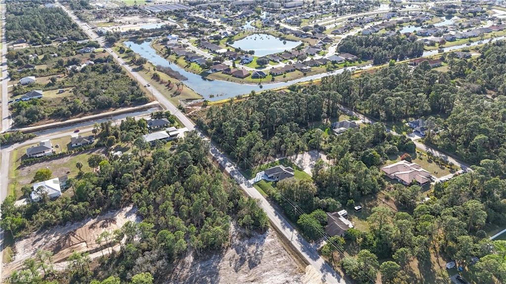 809 Williams Avenue Lehigh Acres, FL 33972 - Photo 31 of 33 an aerial view of residential houses with outdoor space and trees