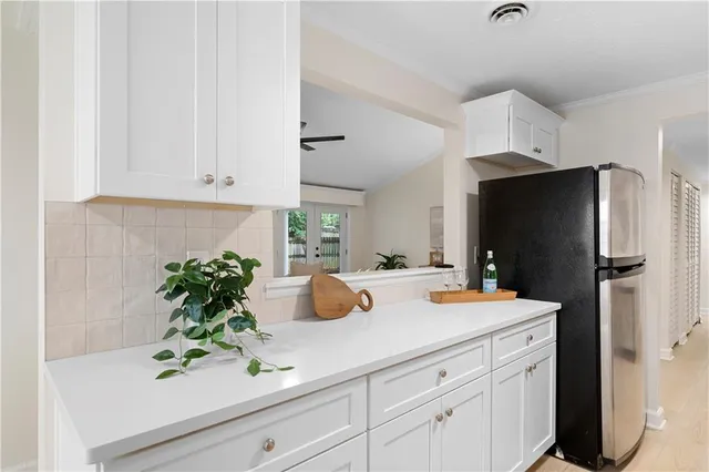 a kitchen with sink and refrigerator
