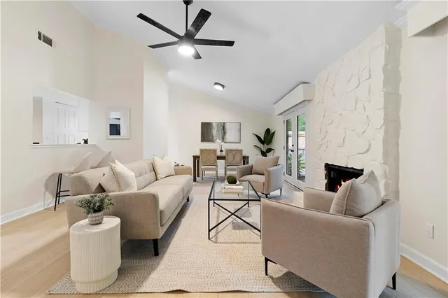 a living room with furniture and a fireplace