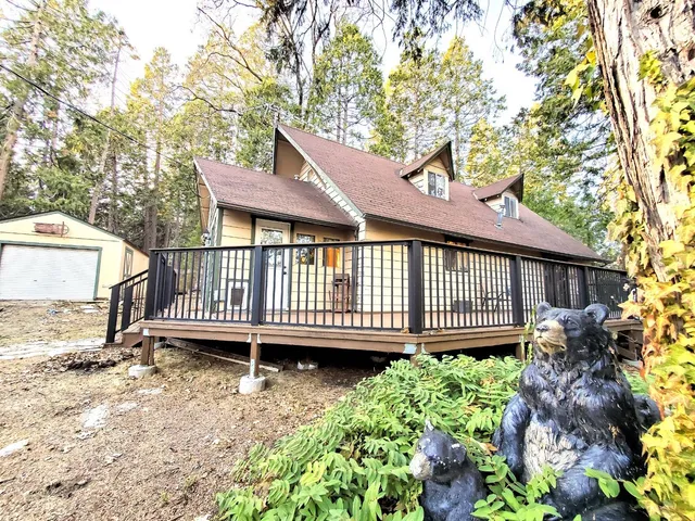 a view of a house with a yard and sitting area