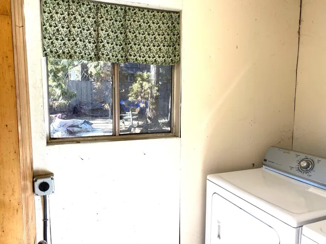 a view of a wooden deck with a yard