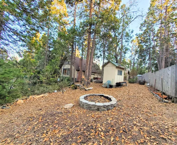 a view of a backyard with wooden fence