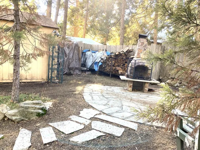 a view of a house with a tree in front of it