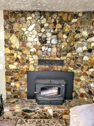 a view of a bedroom with a large window and kitchen view