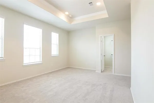 an empty room with windows and closet