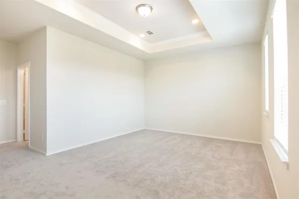 an empty room with windows and closet