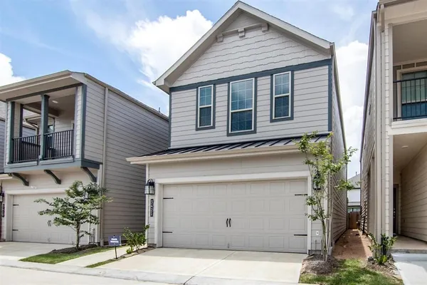 a view of a house with a garage and window
