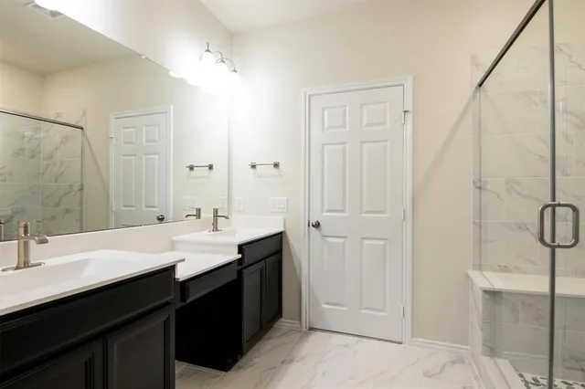 a bathroom with a double vanity sink a and a mirror