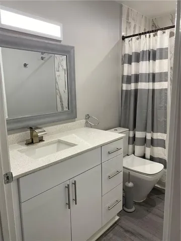 an empty room with wooden floor and closet