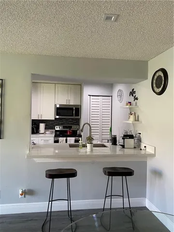 a view of a workspace with furniture and wooden floor