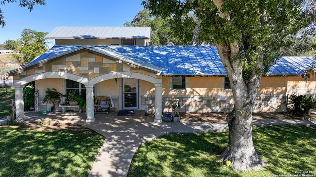 a view of a house with yard and sitting area