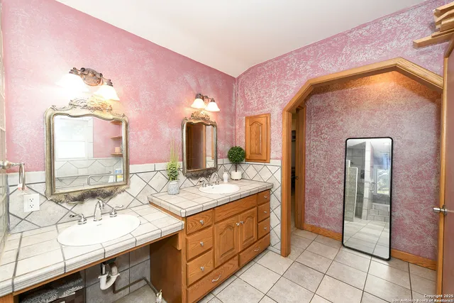 a bathroom with a sink vanity and a mirror