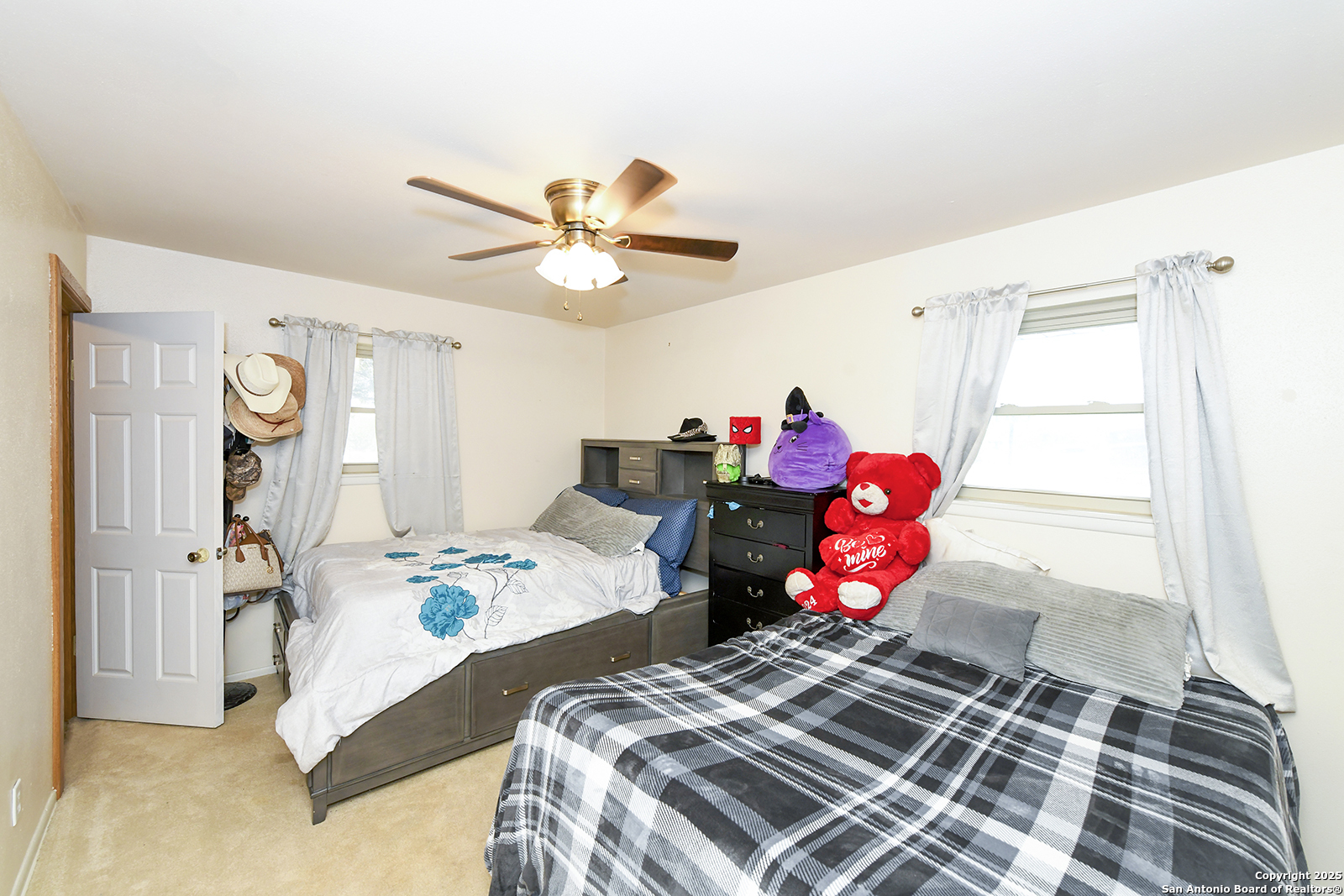 4720 Rakowitz Road Adkins, TX 78101 - Photo 17 of 35 a bedroom with a bed and a chandelier