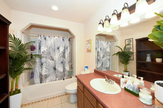 a bathroom with a sink vanity mirror and toilet