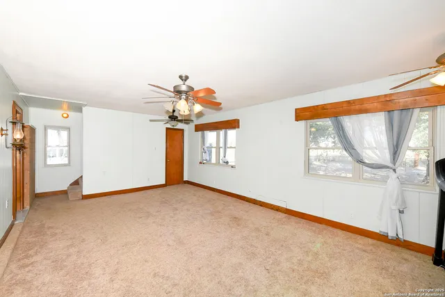 a view of a livingroom with an empty space and a window