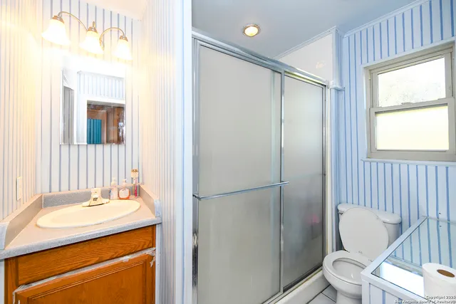 a bathroom with a sink toilet and shower