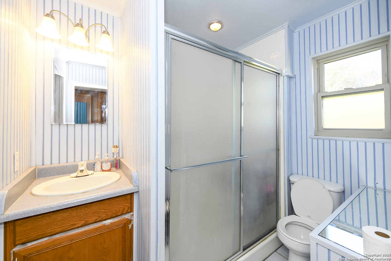 4720 Rakowitz Road Adkins, TX 78101 - Photo 22 of 35 a bathroom with a sink toilet and shower