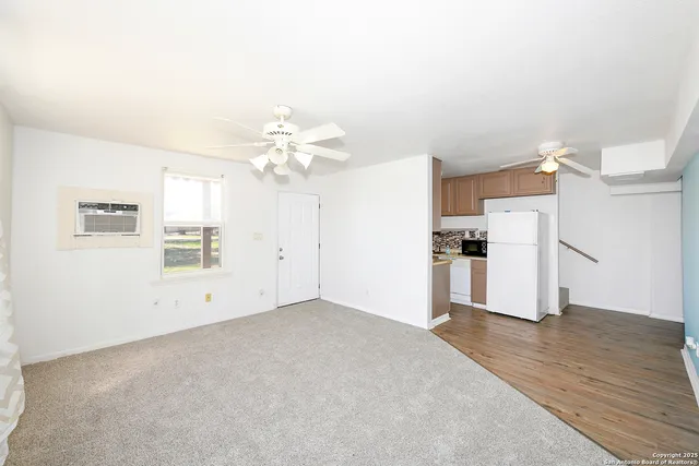 a view of a kitchen with wooden floor and a kitchen space