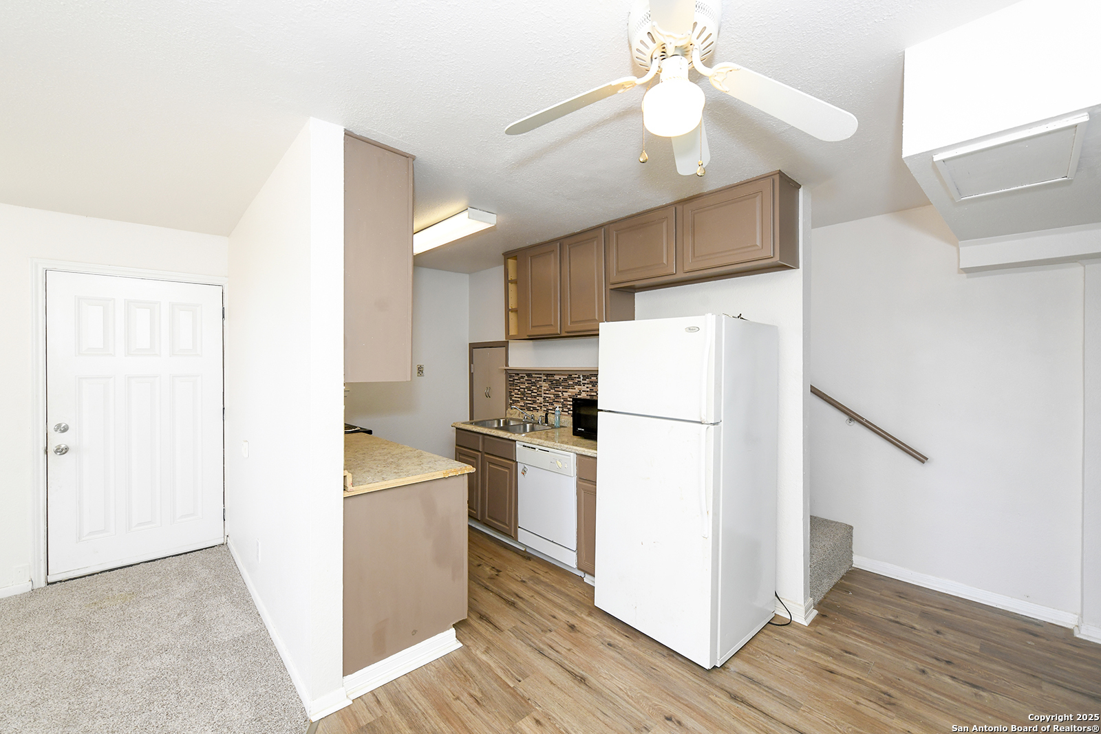4720 Rakowitz Road Adkins, TX 78101 - Photo 25 of 35 a kitchen with a refrigerator a sink and dishwasher