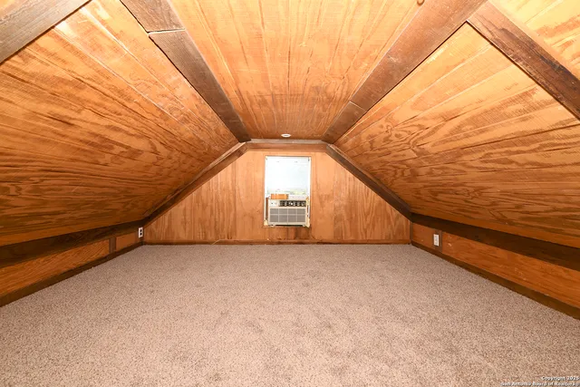 a view of an empty room with windows