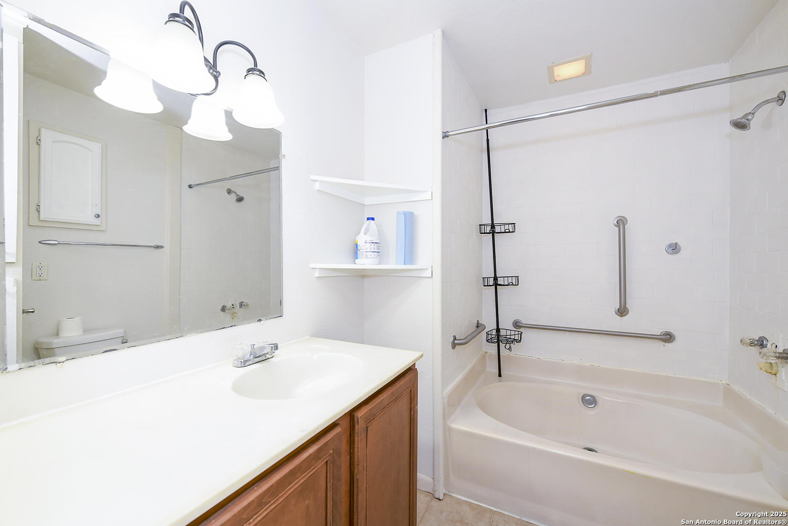 4720 Rakowitz Road Adkins, TX 78101 - Photo 28 of 35 a bathroom with a tub sink and mirror