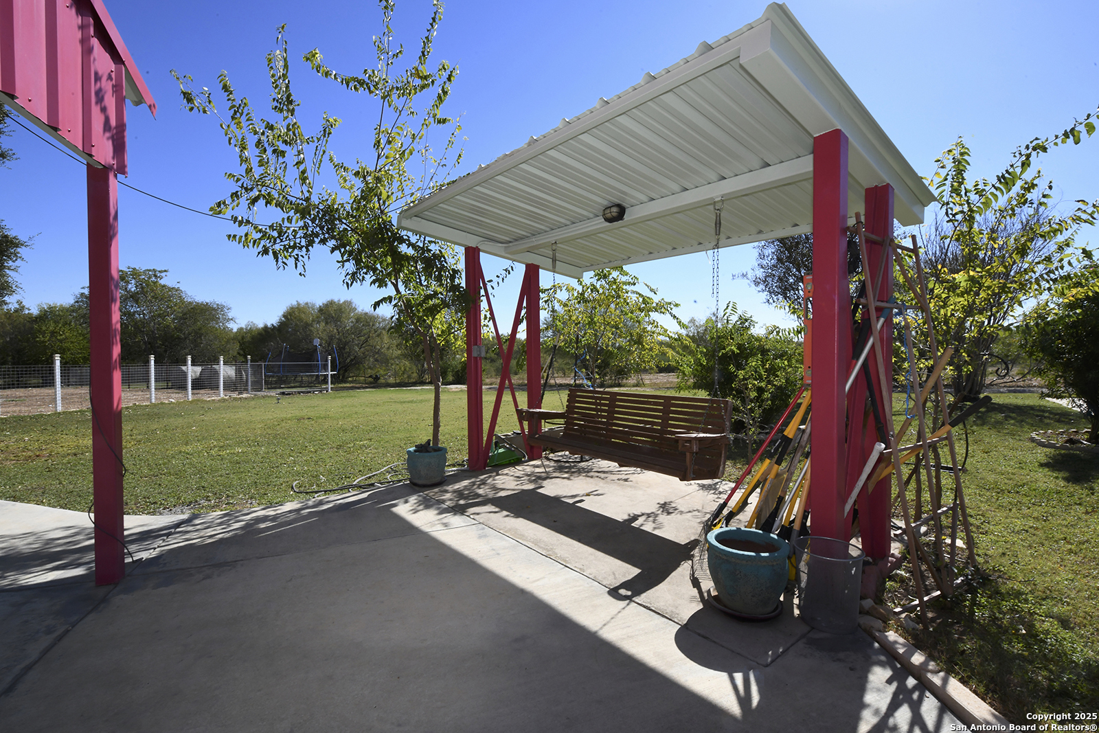 4720 Rakowitz Road Adkins, TX 78101 - Photo 30 of 35 a view of a patio with a table and chairs and potted plants