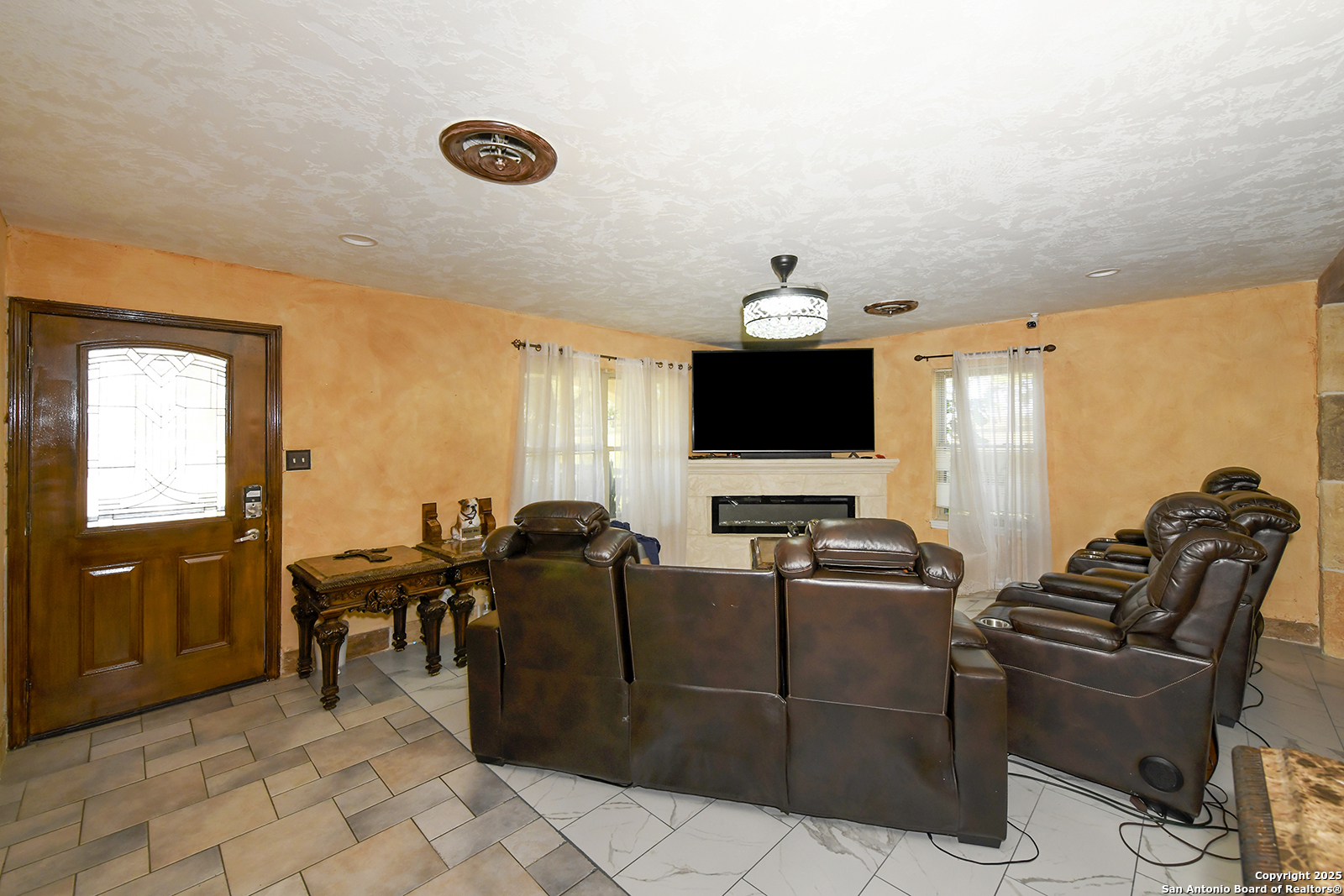 4720 Rakowitz Road Adkins, TX 78101 - Photo 9 of 35 a living room with furniture a flat screen tv and kitchen view