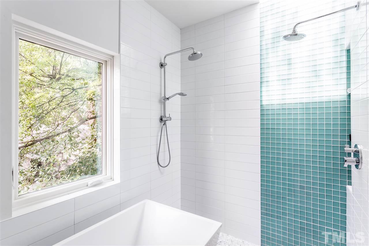 567 New Bern Avenue Raleigh, NC 27601 - Photo 19 of 30 a bathroom with a bath tub and a shower