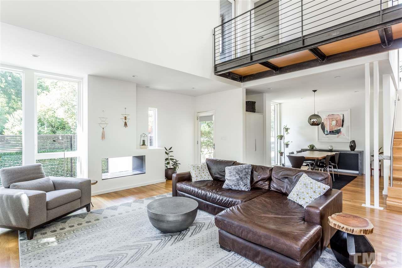 567 New Bern Avenue Raleigh, NC 27601 - Photo 3 of 30 a living room with furniture and a large window