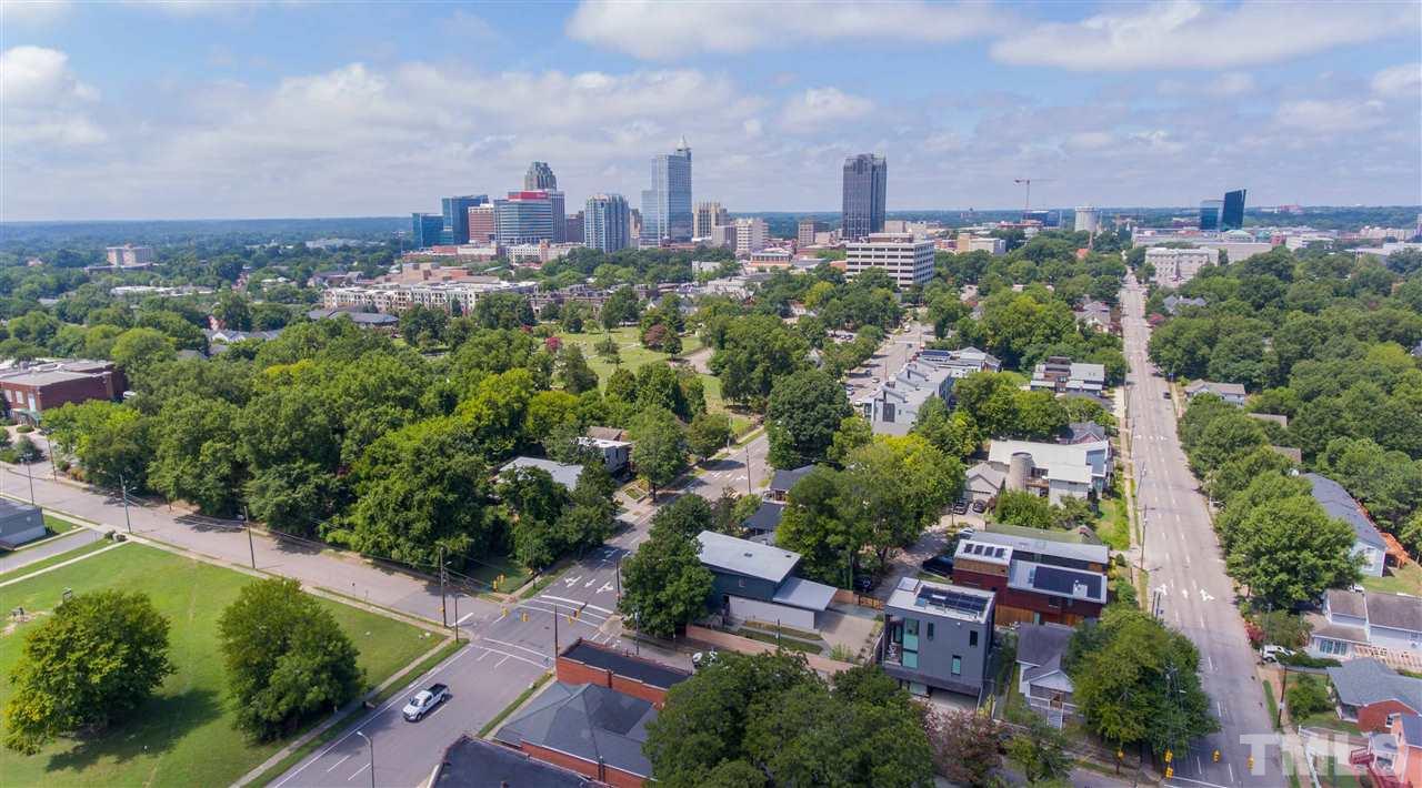 567 New Bern Avenue Raleigh, NC 27601 - Photo 29 of 30 an aerial view of a city with lots of residential buildings green landscape and ocean view