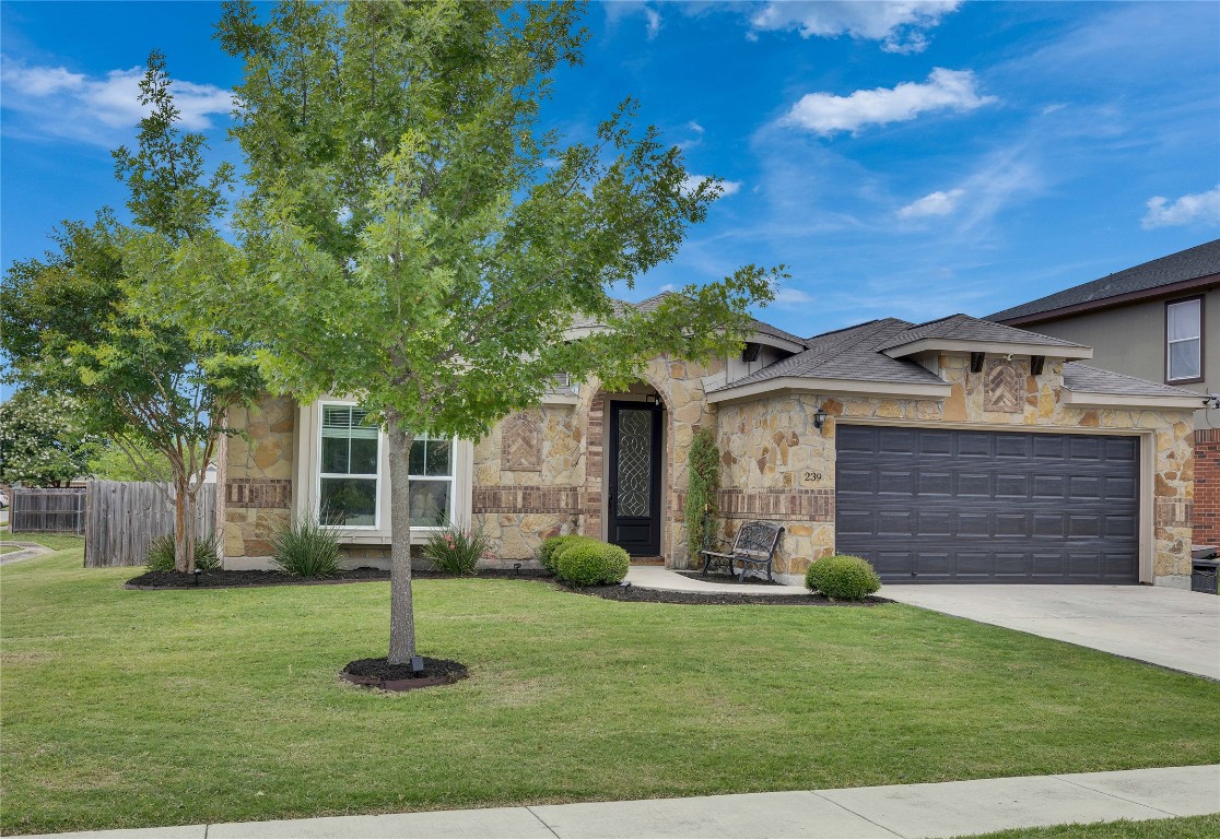 a front view of a house with a garden