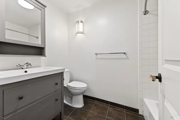 a bathroom with a sink toilet a mirror and vanity
