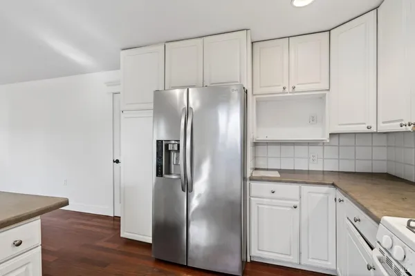 a kitchen with stainless steel appliances granite countertop a refrigerator and a stove top oven