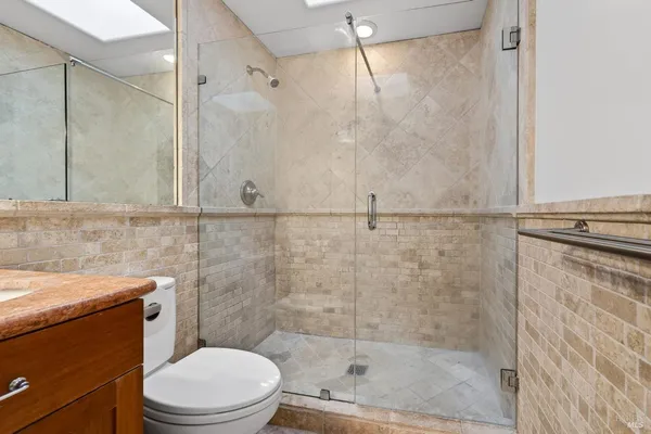 a bathroom with a shower a toilet and sink