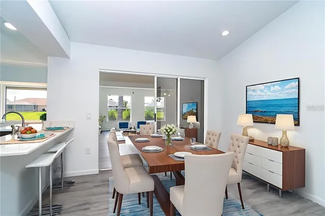 a view of a hallway with wooden floor and a living room