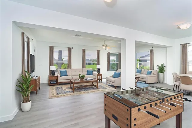 a kitchen with stainless steel appliances kitchen island granite countertop a stove a sink and a refrigerator